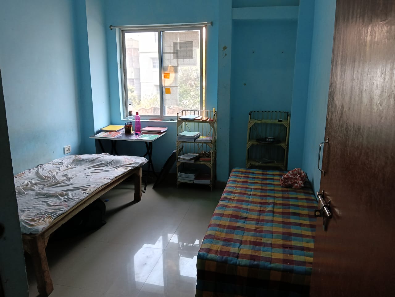 Double sharing room with beds and study table — boys hostel near Boring Road, Patna